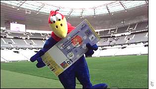 Mascot Footix holds a replica of a ticket for the World Cup in Paris in 1998.